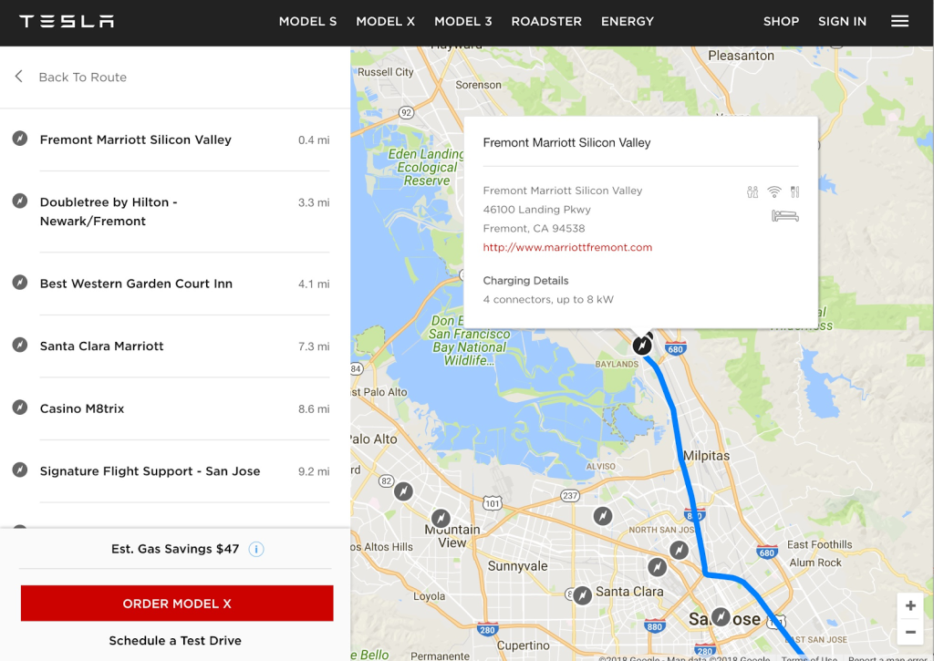 Tesla route planner screenshot showing a Bay Area map with a blue route, stop options like Fremont Marriott, and estimated gas savings of $47.