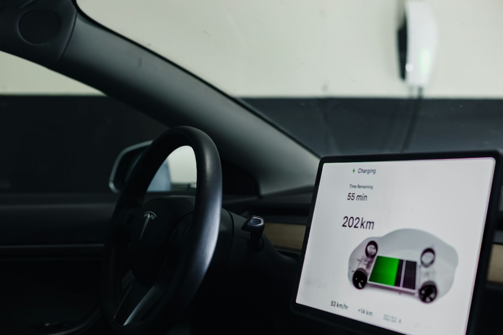 EV interior showing touchscreen with charging status.